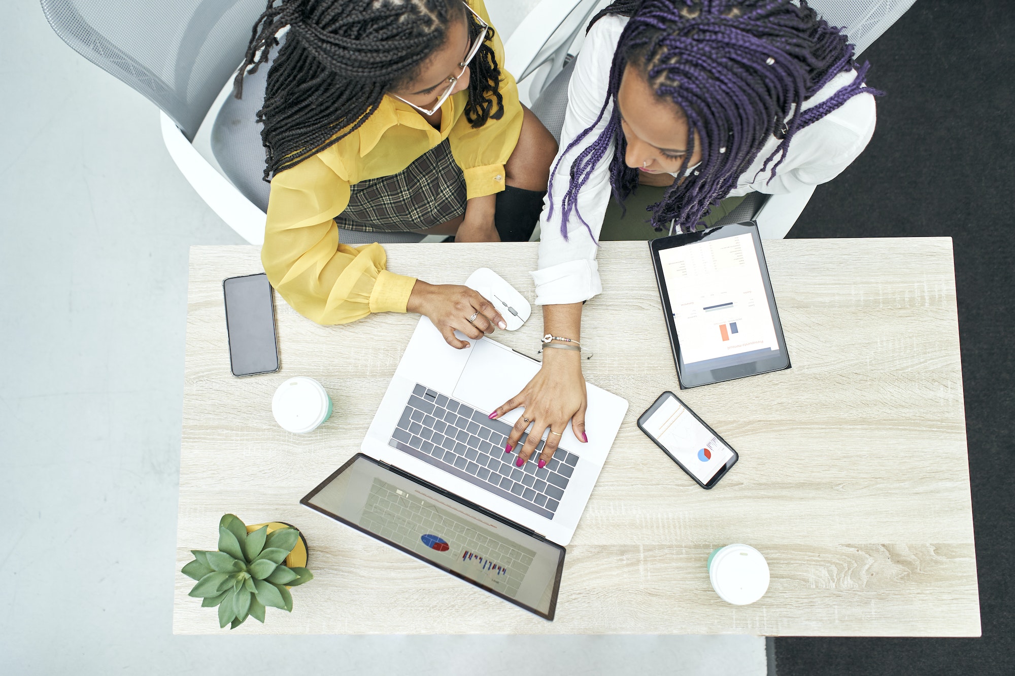 top-view-of-two-young-black-women-working-in-the-office.jpg